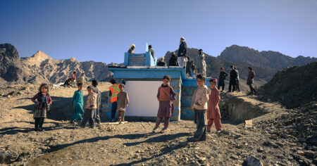 AFGHANISTAN - Community members stand on a tank installed in East Kong Jagathu, a village of Chak district, Maidan Wardak province, as part of an ambitious pipe scheme project implemented by SCA-ABADEI and giving access to clean water to 1800 households in the area. The photo was taken on 11.30.22 and the project inaugurated on 12.12.22.(Photo taken by Elise Blanchard)