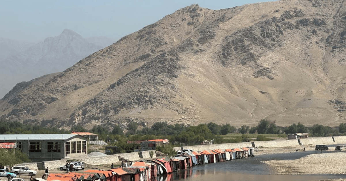 Photo of mountains and a village in the foreground.